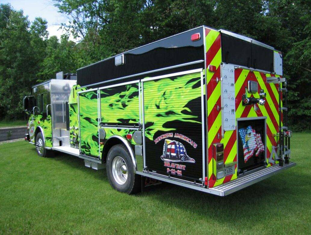 Green Flame Fire Truck Graphics on Grassy Lot in Appleton, WI